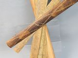 some sticks of wood sitting on top of a table next to a piece of paper