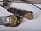 a close up of a knife and a belt on a table