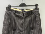 grey pinstripe pants on a hanger against a white wall
