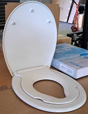 a toilet that is sitting on the floor next to a book