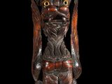 a wooden statue of a man with a bird on his head