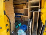 a yellow van that has a bunch of tools in it