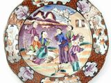 a plate with a picture of people on it