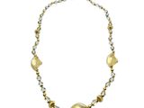 a close up of a necklace on a white background