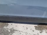 a car that has been dented and is parked on the side of the road