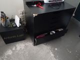 a black desk with a computer on top of it