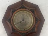 a wooden clock hanging on the wall on the wall