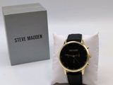 the watch is sitting on a pillow next to a box