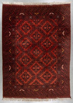 a red and brown rug with a diamond design on it
