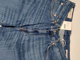 a pair of blue jeans sitting on top of a white table