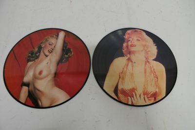 two marilyn monroe pictures on a white surface with a red background