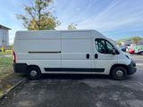 a white van parked in a parking lot next to a building