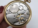 a close up of a person holding a pocket watch