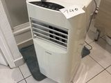 a small air conditioner sitting in the corner of a bathroom