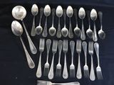 a lot of silver spoons and forks on a table