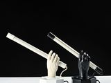 a black and white sculpture of a hand holding a cigarette