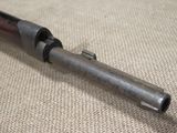 an old gun is laying on a cloth covered surface