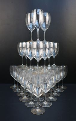 a lot of wine glasses stacked on top of each other