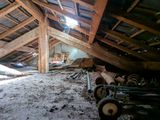 a pile of wood in the attic of an old house
