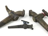 four pieces of old tools are laying on a white surface