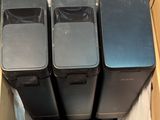 three black trash cans in a cardboard box sitting on top of a white sheet