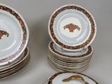 many plates with different designs on them sitting on a table