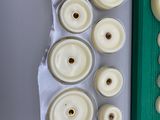 many candles that are sitting on a table next to a cutting board