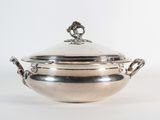 an antique silverplated bowl with a lid and handles on a white background