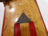 a close up of a wooden object with a triangle on it