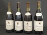 four bottles of wine are lined up on a table