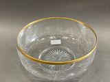 a glass bowl with a gold rim sitting on a table