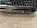 the rear end of a car with a black grill and bumper