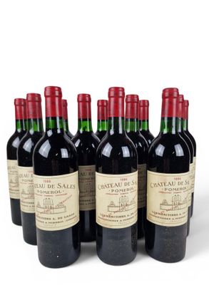 six bottles of red wine lined up in a row on a white surface