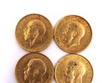 four gold coins with a picture of a man and a woman on them
