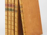 three books are stacked on top of each other on a white surface