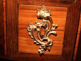 a close up of a wooden cabinet with a metal handle