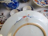 many plates and bowls on the table with blue and white designs