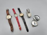 Plusieurs modèles de montres sont exposés sur une table.