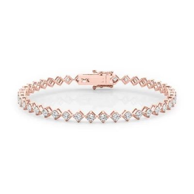 a rose gold bracelet with diamonds on a white background