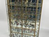 a glass display case with a lot of figurines in it