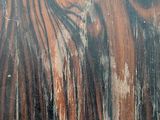 a close up view of a wooden surface with peeling paint