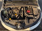the engine of a car with its hood open on the street