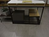 a white table with a laptop on top of it