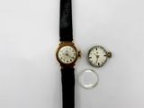 an image of a couple of watches sitting on top of a white surface