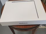 a white box sitting on top of a wooden table next to a wall