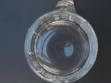 a glass bottle that is sitting on a table