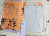an open book on a table with papers on it