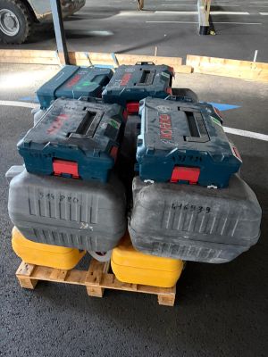 a pile of tools sitting on a pallet in a parking lot