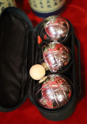three balls in a case with a wooden spoon in it