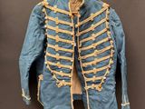 une vieille veste militaire bleue accrochée à un crochet au mur